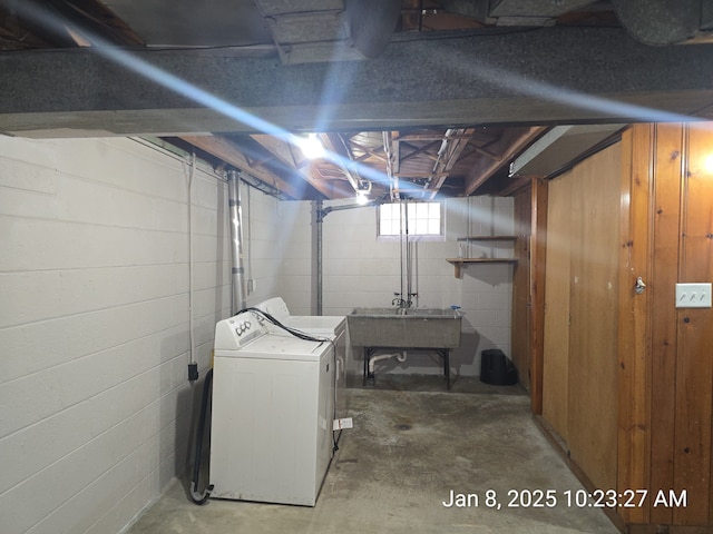 laundry room featuring sink and wooden walls