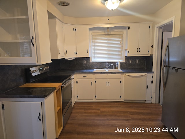 kitchen featuring appliances with stainless steel finishes, sink, backsplash, white cabinets, and dark hardwood / wood-style floors