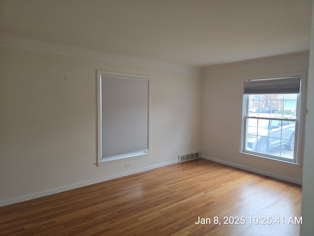 unfurnished room with light hardwood / wood-style flooring