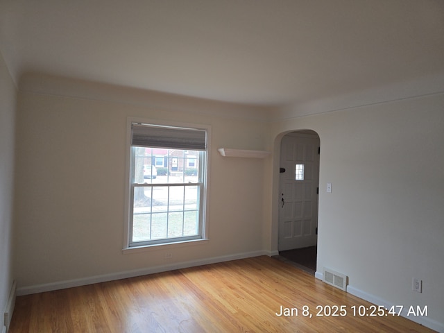 empty room with light hardwood / wood-style flooring