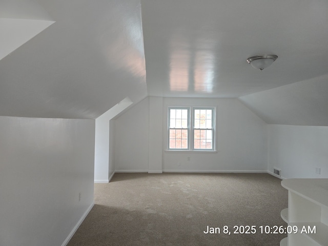 bonus room with carpet and lofted ceiling