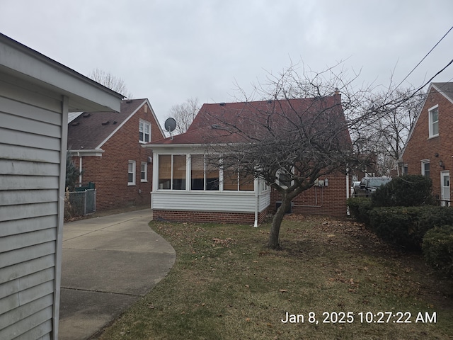 rear view of property featuring a yard