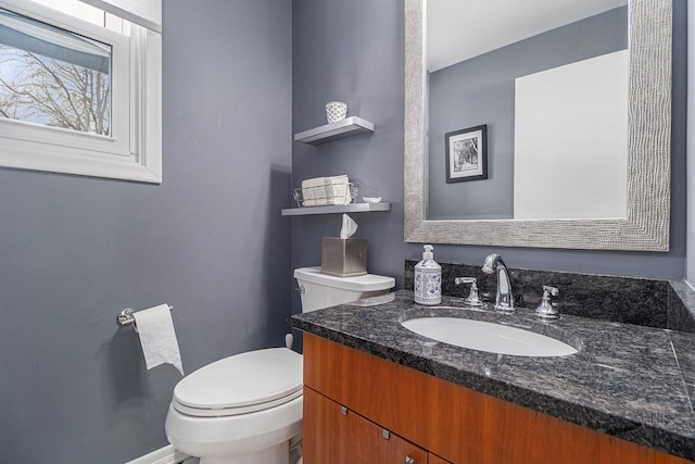 bathroom featuring toilet and vanity