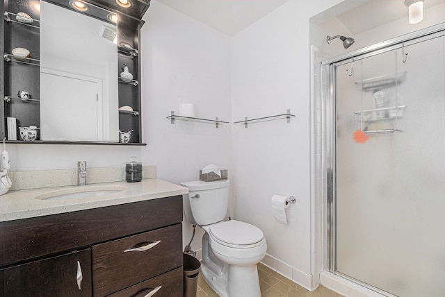 bathroom with vanity, toilet, tile patterned floors, and walk in shower