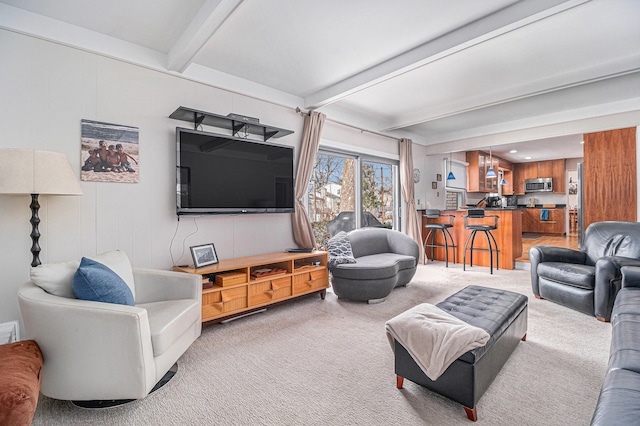 living room with carpet, beam ceiling, and wood walls