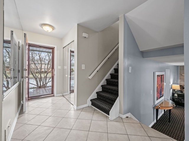 foyer entrance with light tile patterned flooring