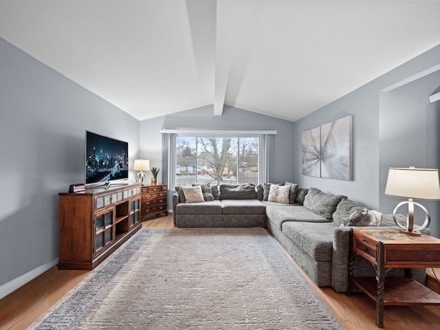 living room featuring vaulted ceiling with beams and wood-type flooring