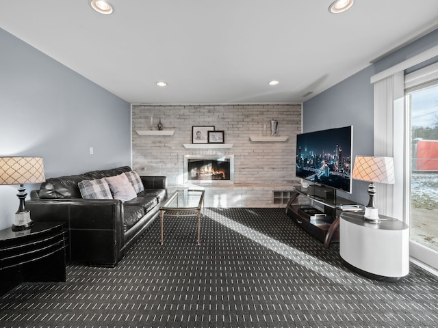 carpeted living room with a brick fireplace