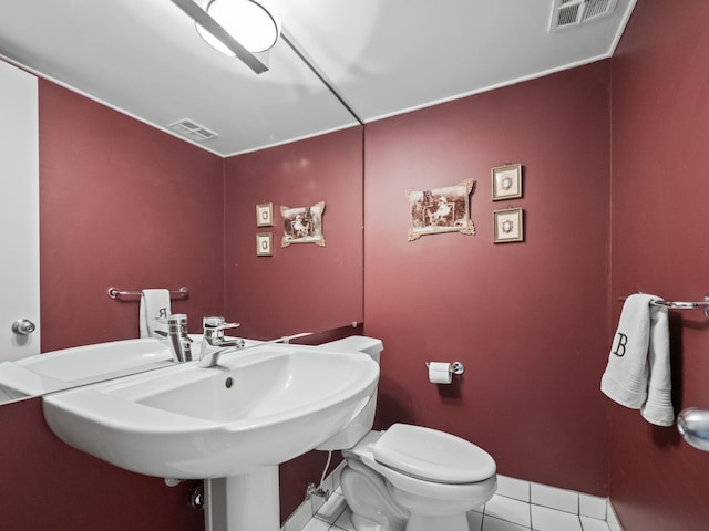 bathroom with tile patterned flooring, toilet, and sink