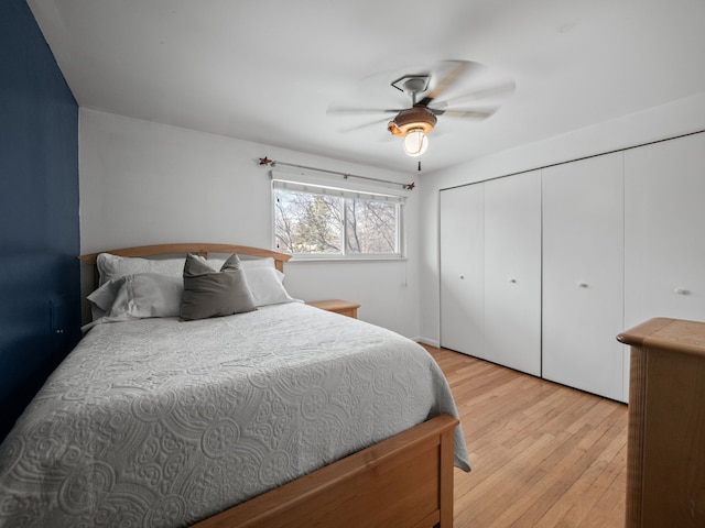 bedroom with ceiling fan, a closet, and light hardwood / wood-style flooring