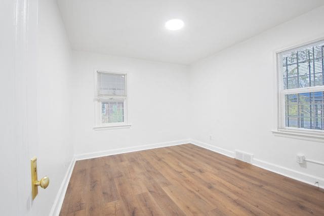 unfurnished room featuring hardwood / wood-style floors