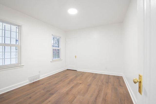 unfurnished room featuring dark hardwood / wood-style floors