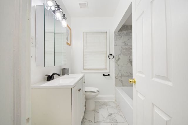 full bathroom with vanity, toilet, and tiled shower / bath