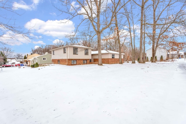 view of snow covered back of property