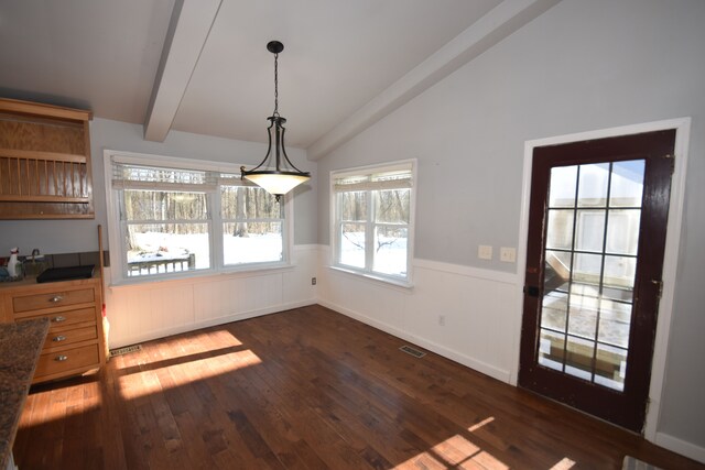 9417 Mabley Hill Rd, Fenton, MI 48430 - unfurnished dining area featuring wainscoting, visible vents, dark wood-style flooring, and lofted ceiling with beams