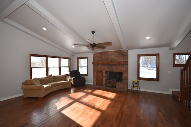 unfurnished living room with a fireplace, dark hardwood / wood-style floors, ceiling fan, and vaulted ceiling with beams