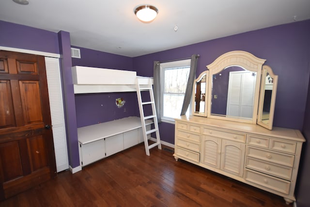 bedroom featuring a closet and dark hardwood / wood-style flooring