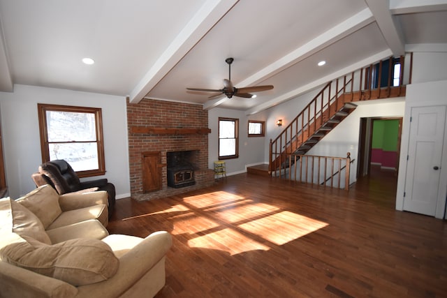 living room featuring ceiling fan, a healthy amount of sunlight, dark wood-type flooring, and vaulted ceiling with beams