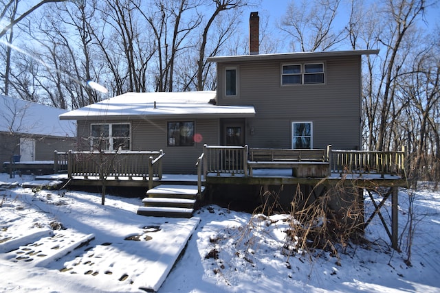 snow covered property featuring a wooden deck