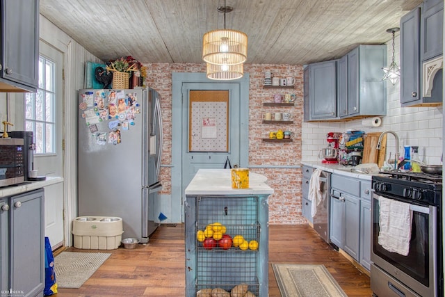 kitchen with a chandelier, hanging light fixtures, wooden ceiling, and appliances with stainless steel finishes