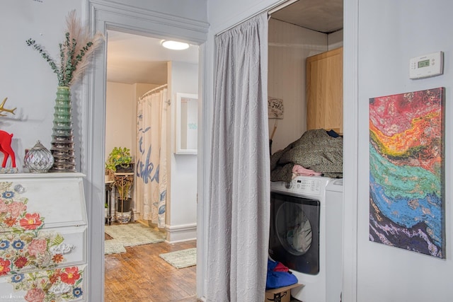 laundry room featuring washer / dryer and wood-type flooring