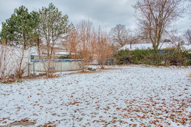 snowy yard with a covered pool