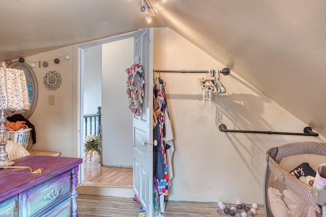 interior space with hardwood / wood-style floors and vaulted ceiling