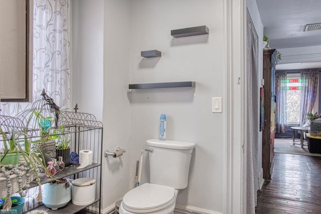 bathroom featuring hardwood / wood-style flooring and toilet