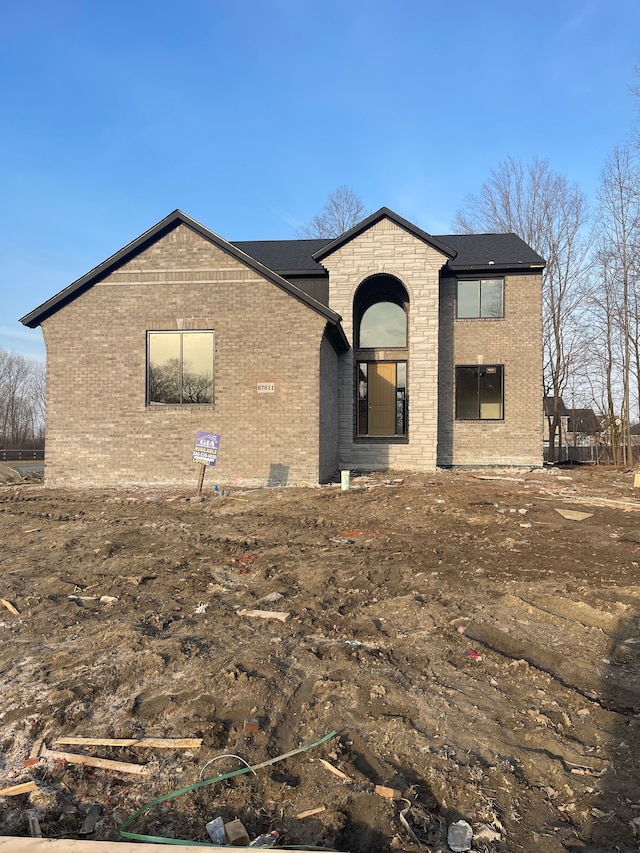 view of front of home with brick siding and stone siding