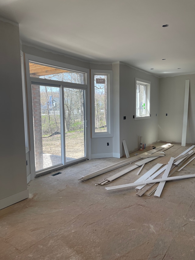 unfurnished room featuring baseboards and ornamental molding