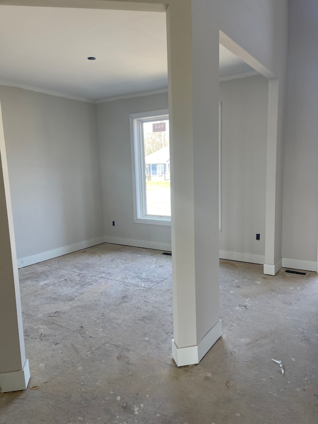 unfurnished room with crown molding, baseboards, and visible vents
