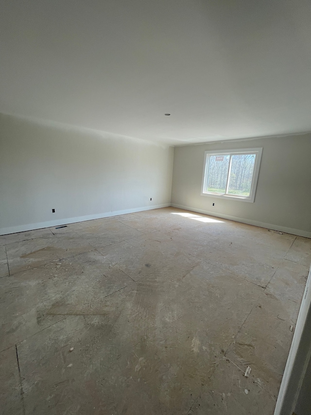 spare room with baseboards