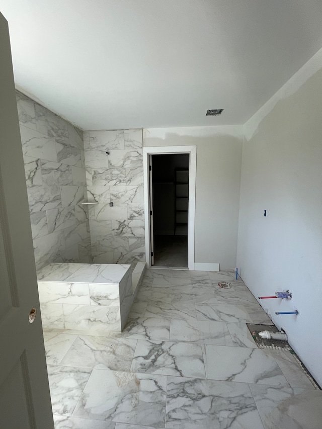 bathroom with visible vents, marble finish floor, and walk in shower