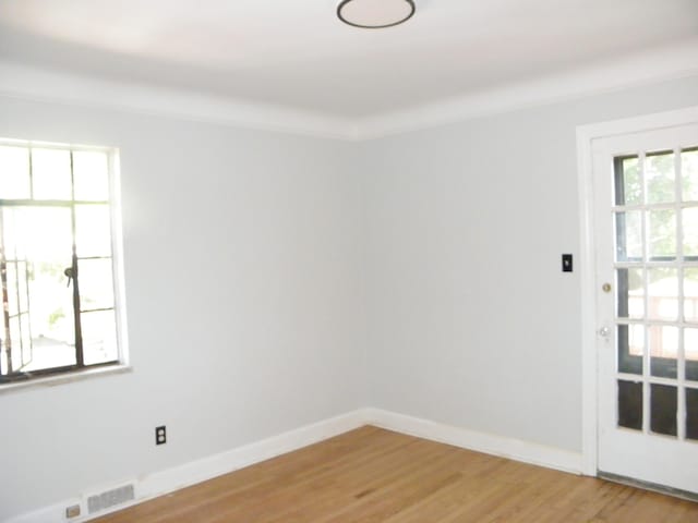 unfurnished room with hardwood / wood-style floors