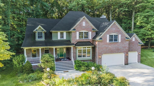 view of front of home featuring covered porch and a garage