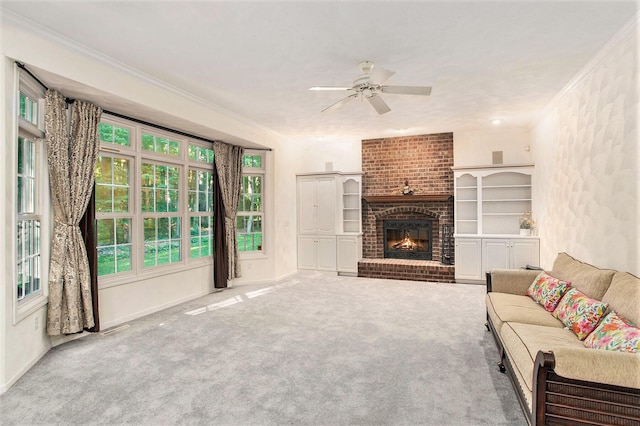 carpeted living room featuring ceiling fan, ornamental molding, and a brick fireplace