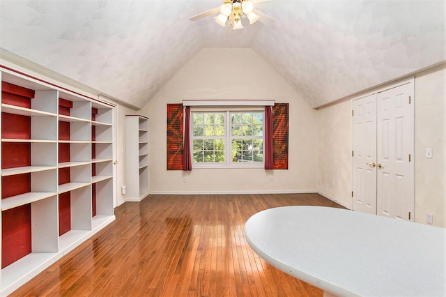 unfurnished bedroom featuring hardwood / wood-style flooring, ceiling fan, and vaulted ceiling