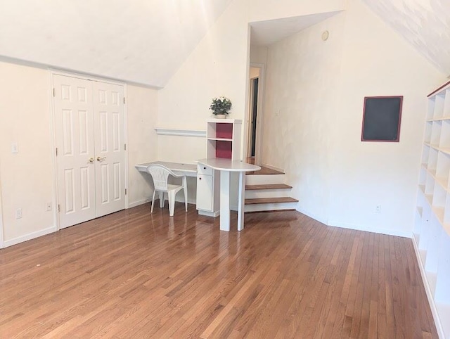 interior space with hardwood / wood-style flooring and lofted ceiling