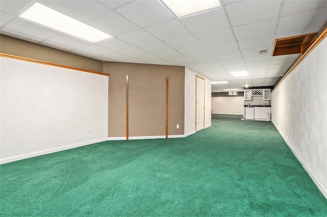 basement with carpet flooring and a paneled ceiling