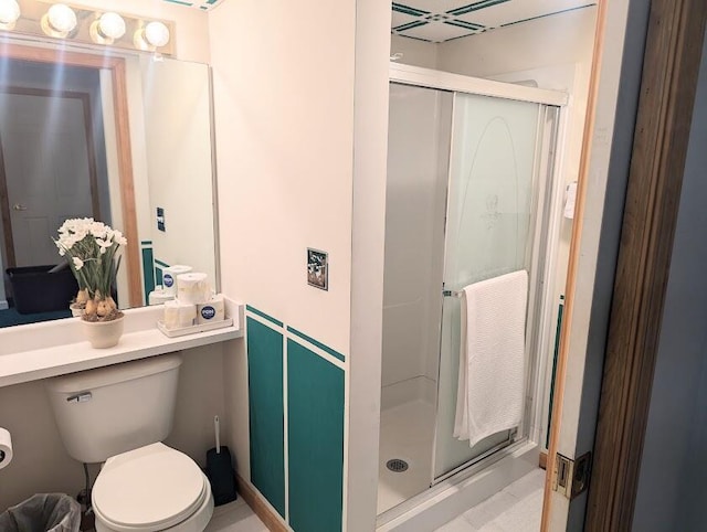 bathroom featuring toilet and walk in shower