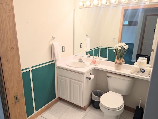 bathroom featuring tile patterned flooring, vanity, and toilet