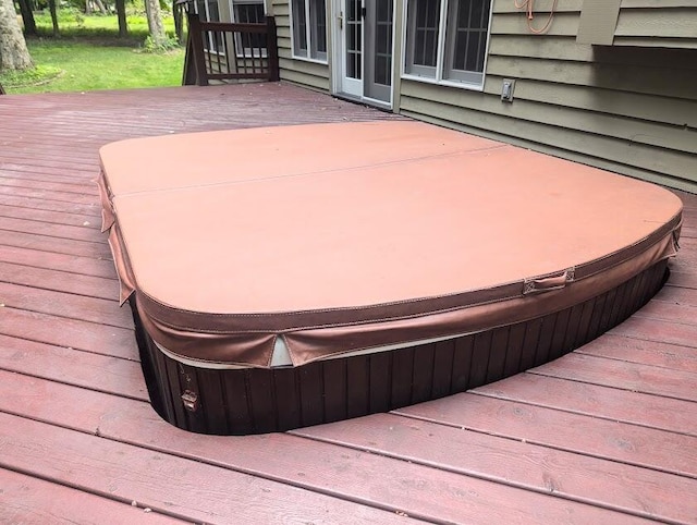 wooden terrace featuring a covered hot tub