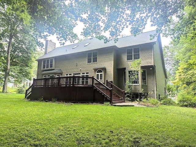 back of house with a deck and a yard