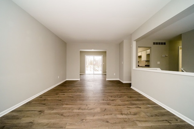 unfurnished room with wood-type flooring