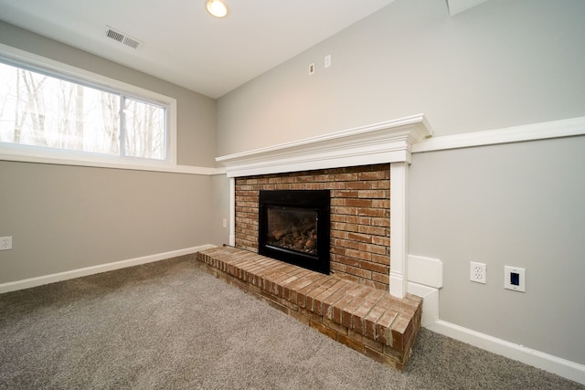 unfurnished living room featuring a fireplace, carpet floors, and lofted ceiling