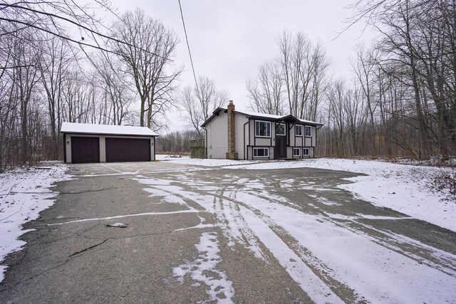 exterior space featuring a garage and an outbuilding