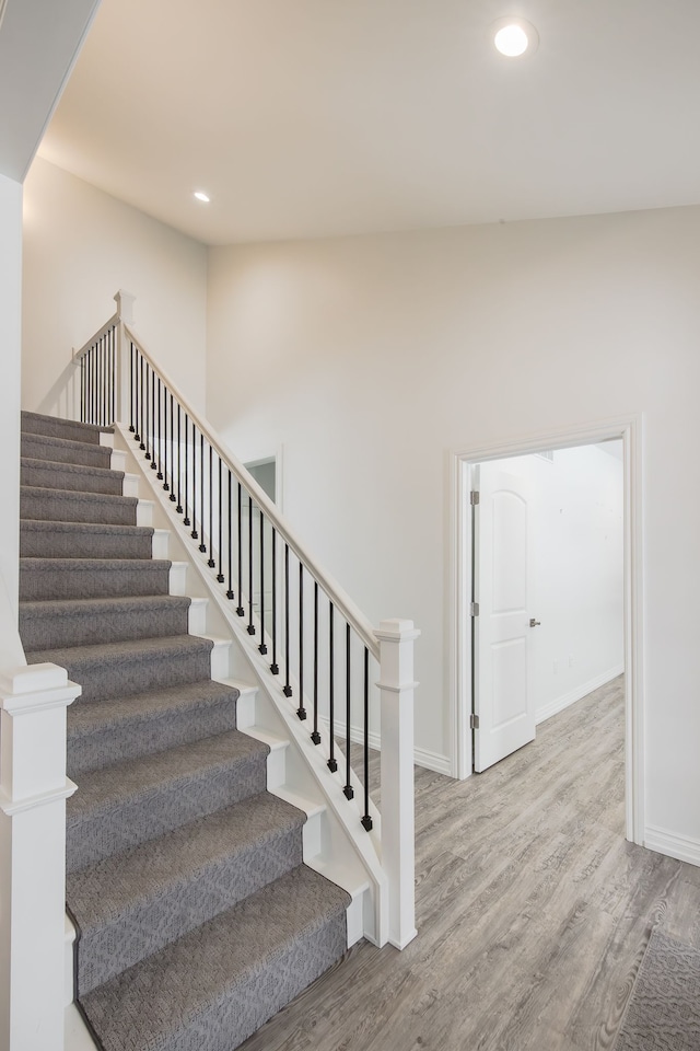 stairs with hardwood / wood-style flooring