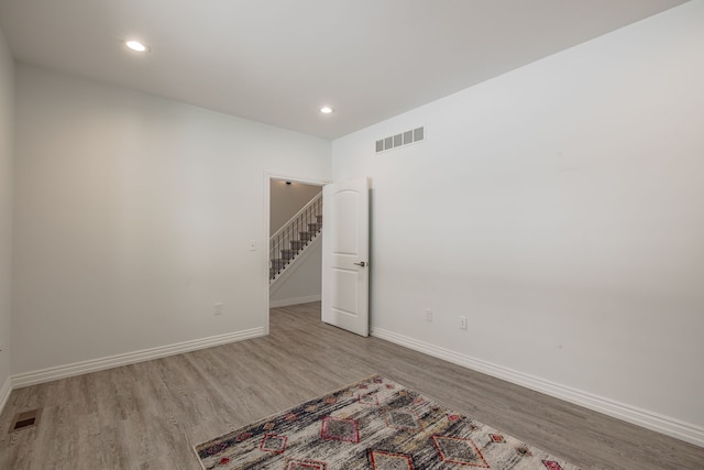 spare room with light hardwood / wood-style flooring