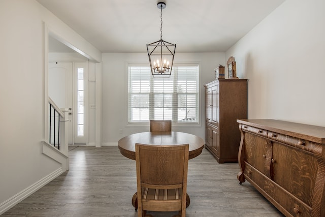 dining space with a chandelier and light hardwood / wood-style flooring