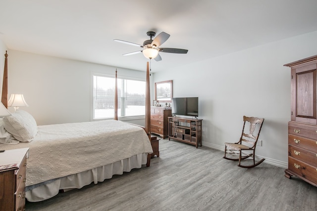 bedroom with light hardwood / wood-style floors and ceiling fan